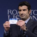 UEFA Champions League Final Ambassador, former Portuguese international footballer Luis Figo holds up the name of Barcelona during the draw for the last 16 of the UEFA Champions league tournament at the UEFA headquarters in Nyon on December 16, 2013.   AFP PHOTO / FABRICE COFFRINI        (Photo credit should read FABRICE COFFRINI/AFP/Getty Images)