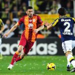 Galatasaray's Burak Yilmaz (C) vies for the ball with Fenerbahce's Egemen Korkmaz (R) during the Turkish Sport Toto Super League football match  Fenerbahce vs Galatasaray at the Fenerbahce Sukru Saracoglu Stadium, in Istanbul, on March 8, 2015. AFP PHOTO /OZAN KOSE        (Photo credit should read OZAN KOSE/AFP/Getty Images)